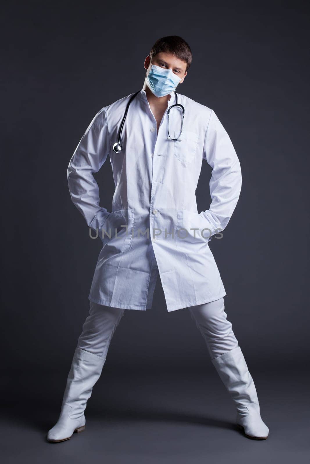 Young sexy striptease dancer in doctor costume. Studio portrait
