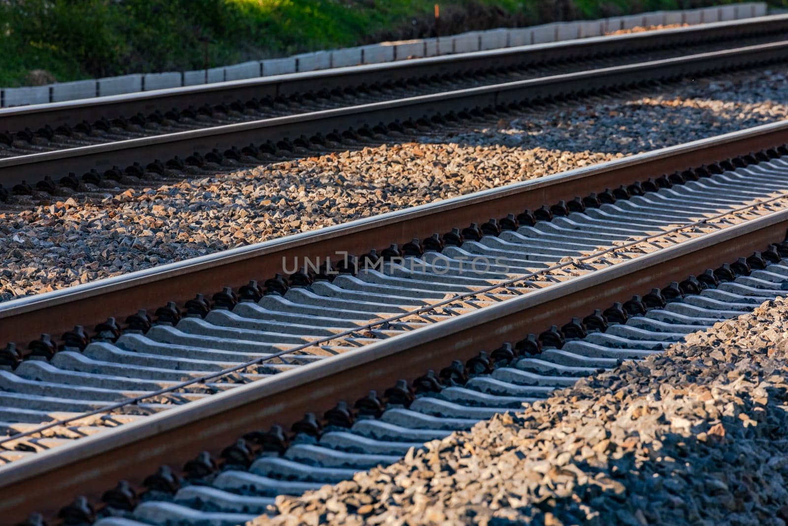 Two parallel tracks with rails, sleepers and wires