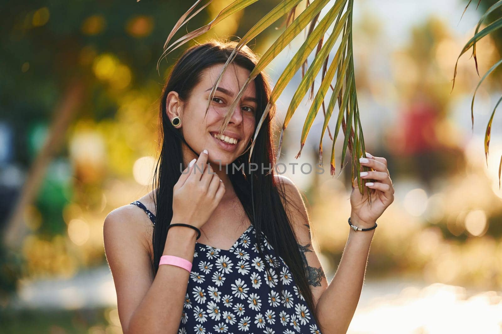 Beautiful young woman is outdoors at sunny daytime. Concept of vacation.