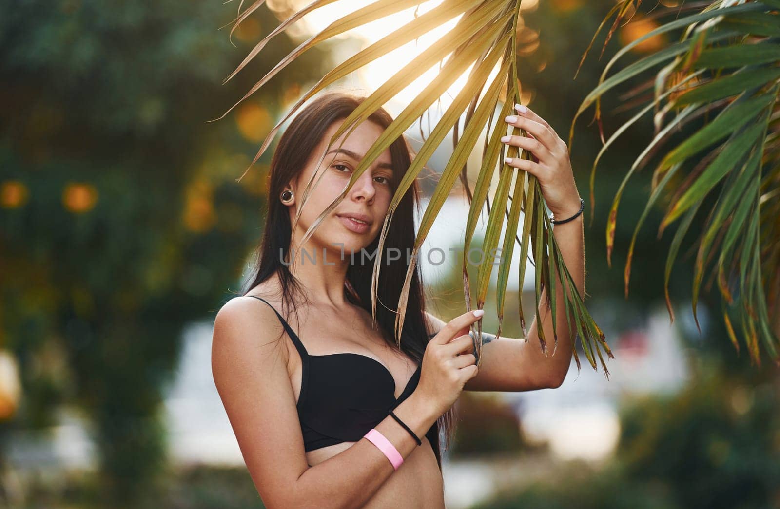 In bra. Beautiful young woman is outdoors at sunny daytime. Concept of vacation.