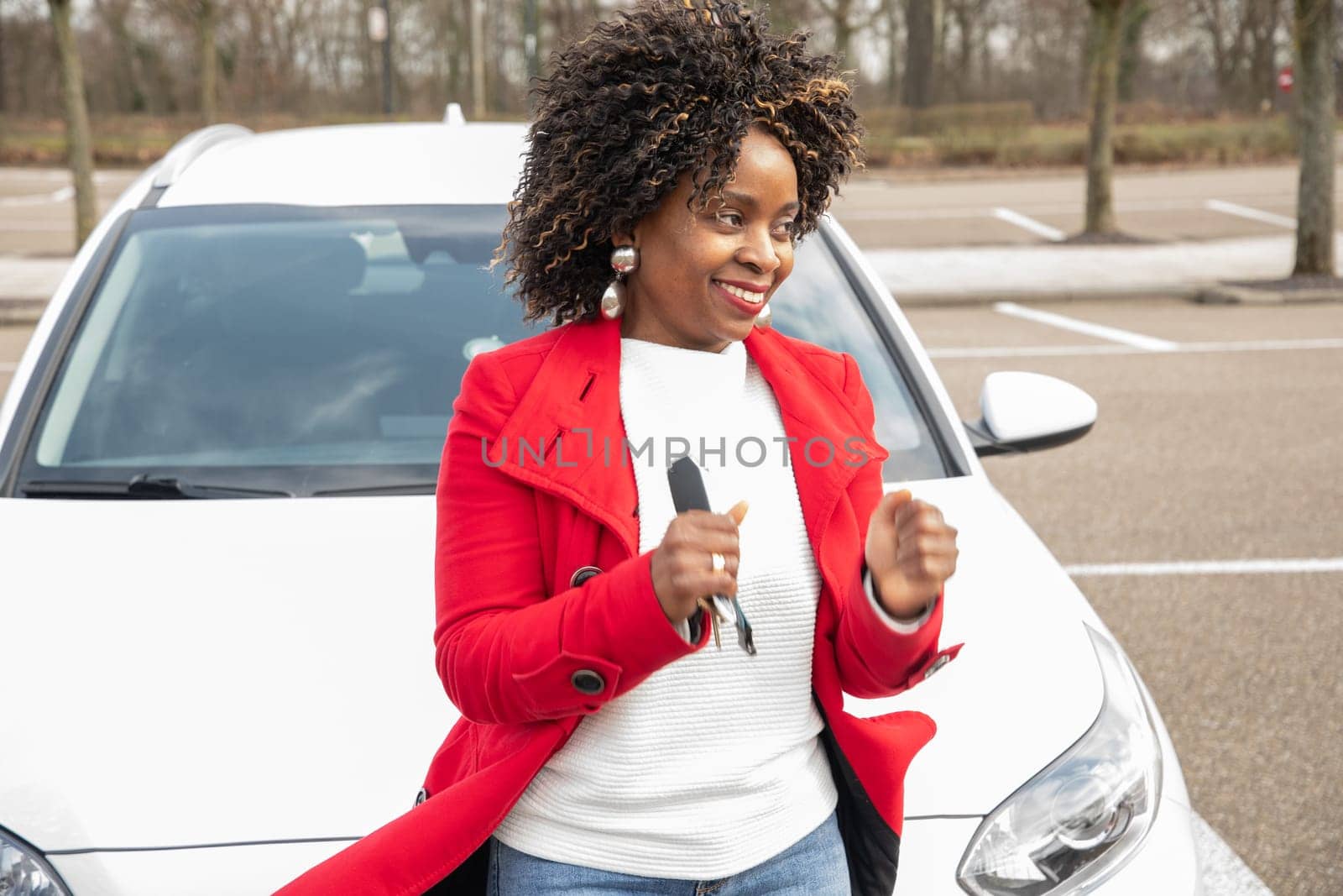 cheerful african american woman goes to car and holding keys,Motion blurred, High quality photo