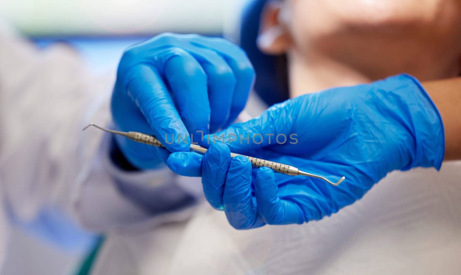 Teamwork makes the teeth cleaning work. a young woman having a dental procedure performed on her