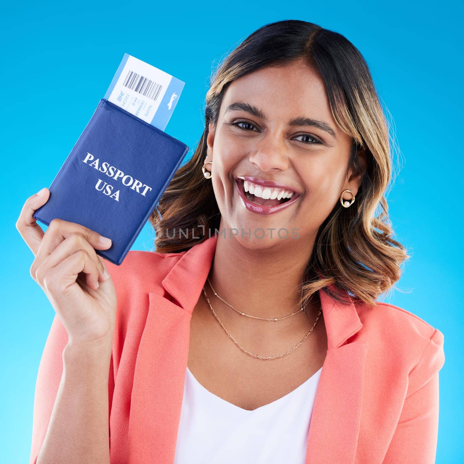 Passport, excited and woman portrait isolated on blue background for USA travel opportunity, immigration or holiday. Identity documents, flight ticket and happy face of young indian person in studio.