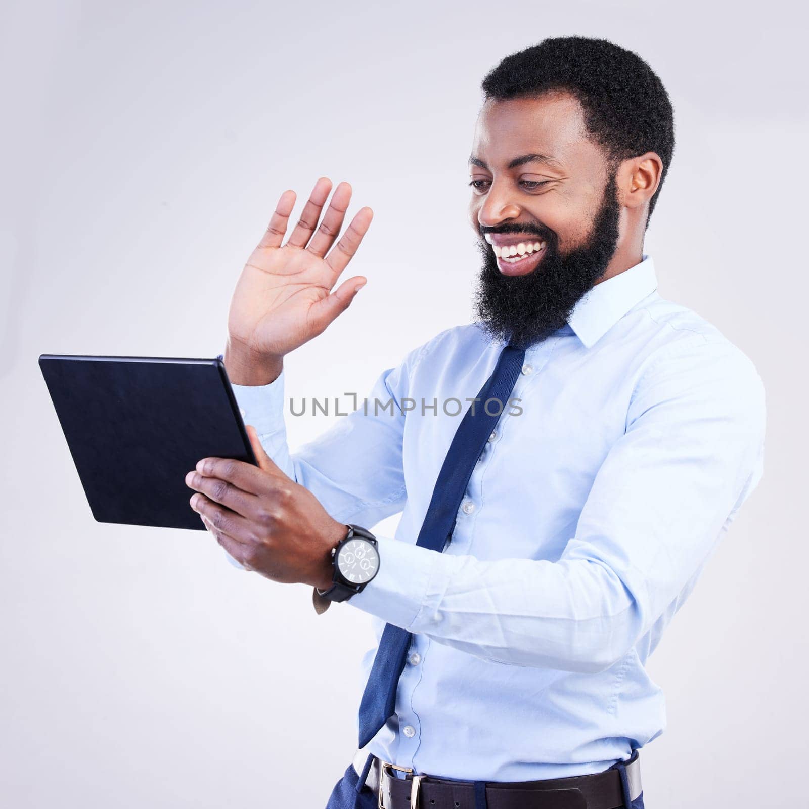 Tablet, video call and man isolated on gray background in online meeting, global networking and business webinar. African corporate person waves hello on digital tech, virtual communication in studio.