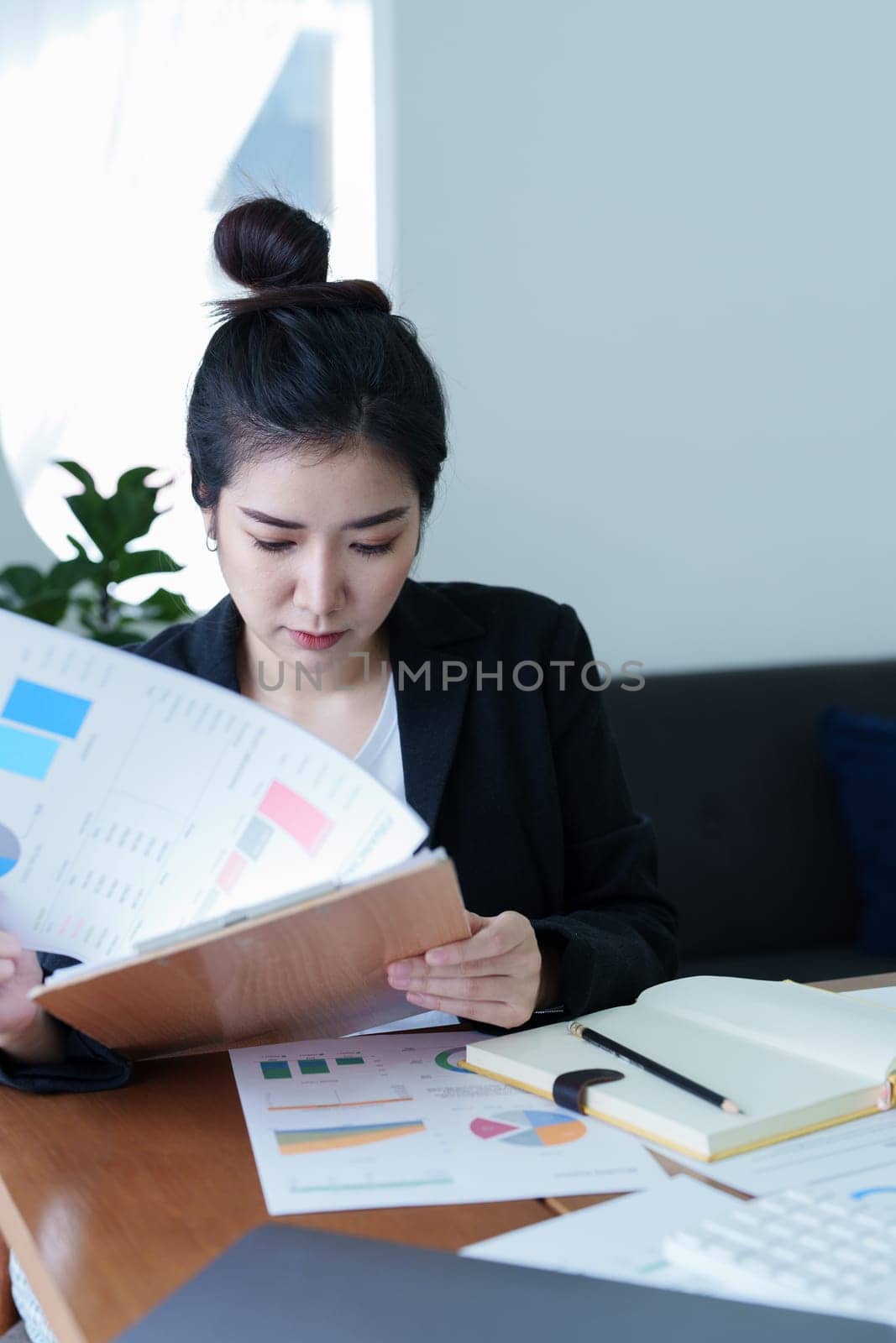 Portrait of a businesswoman checking company's financial statements and income to submit taxes to the IRS.