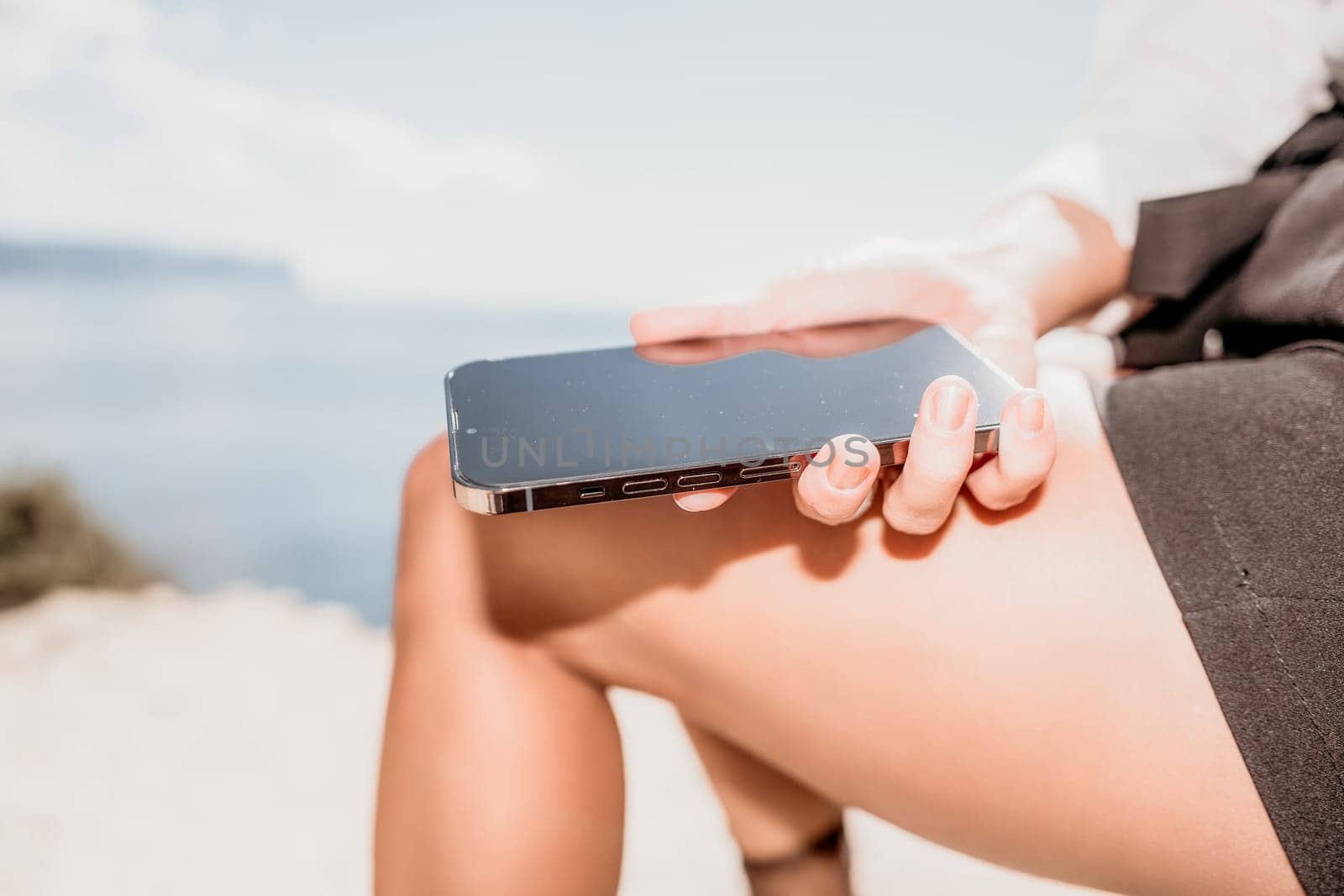 Happy girl doing yoga with laptop working at the beach. beautiful and calm business woman sitting with a laptop in a summer cafe in the lotus position meditating and relaxing. freelance girl remote work beach paradise