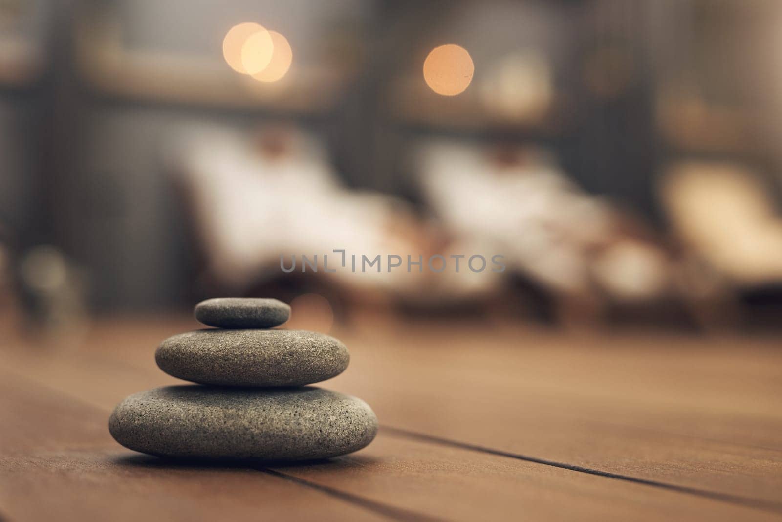 Treat yourself to a spa experience. three stones balanced on top of each other in a spa