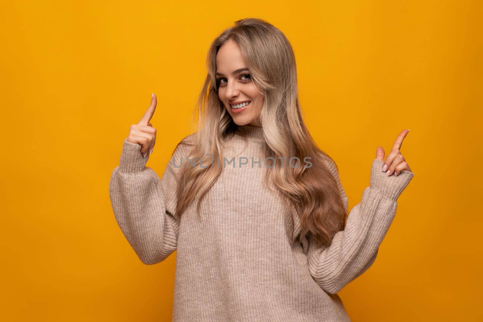 young european woman reporting news on the wall against studio orange background by TRMK
