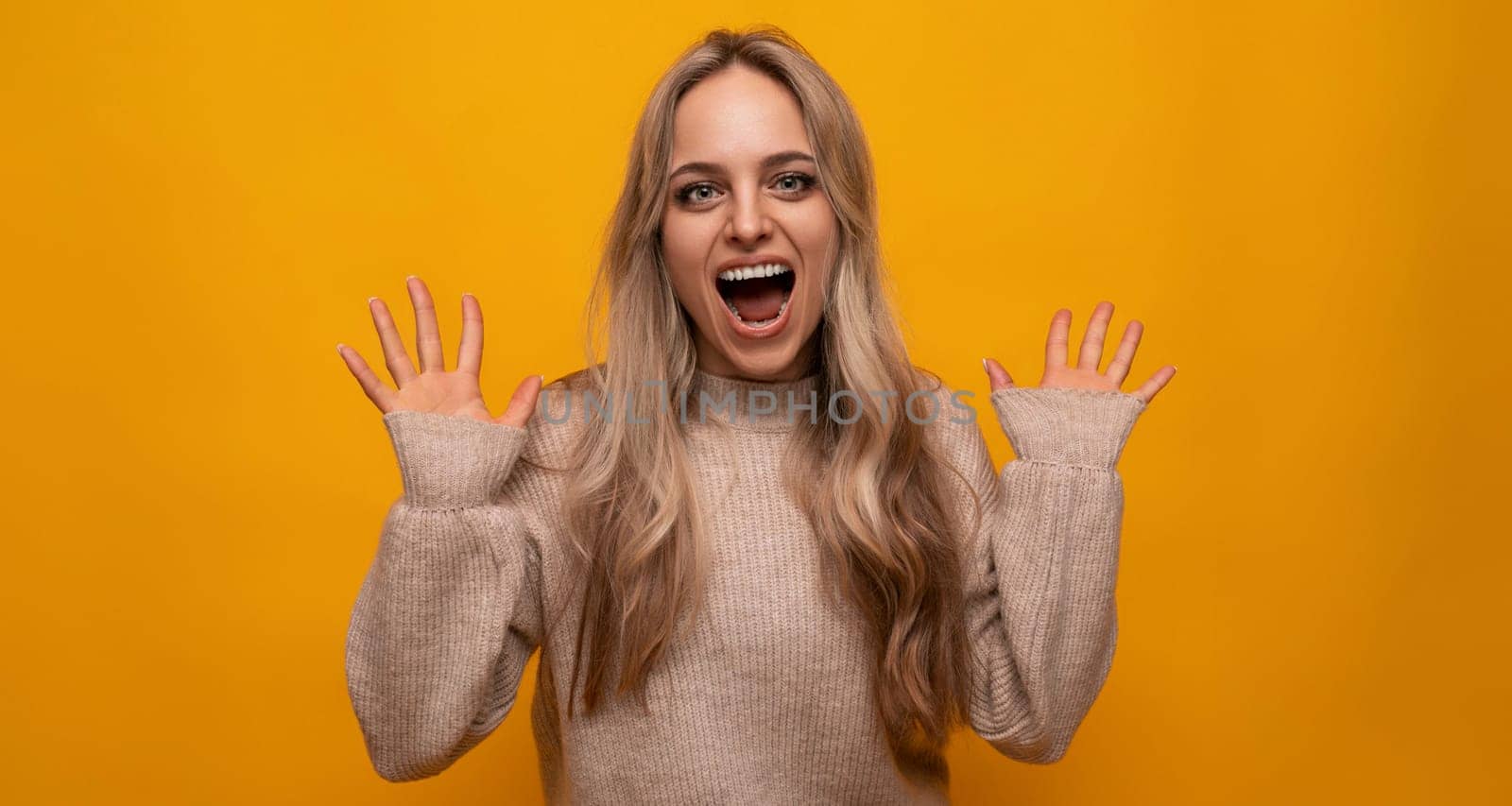 photo of a girl happily waving hand on a yellow background by TRMK