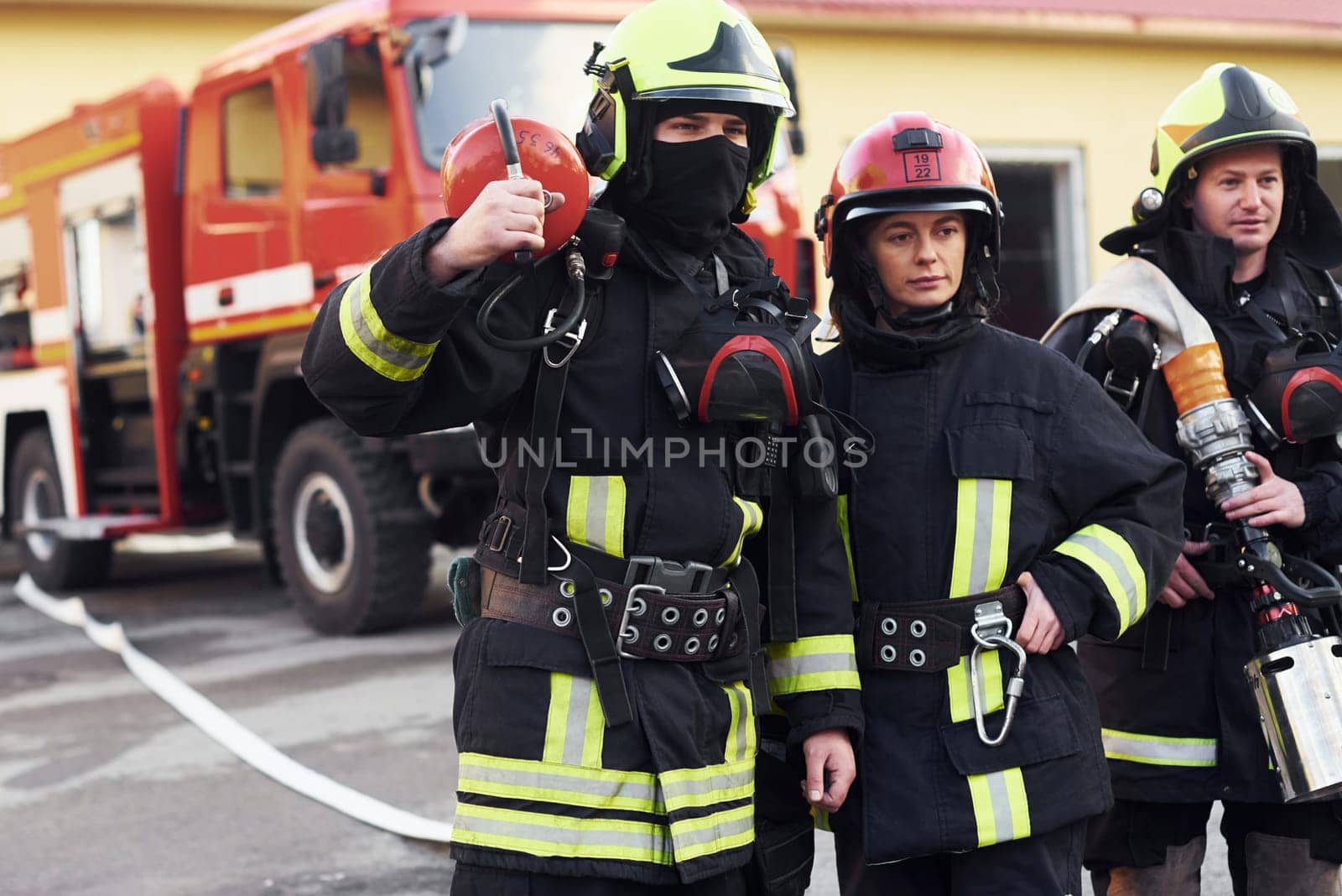 Group of firefighters in protective uniform that is on station.