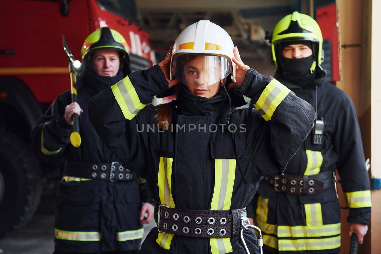 Group of firefighters in protective uniform that is on station.