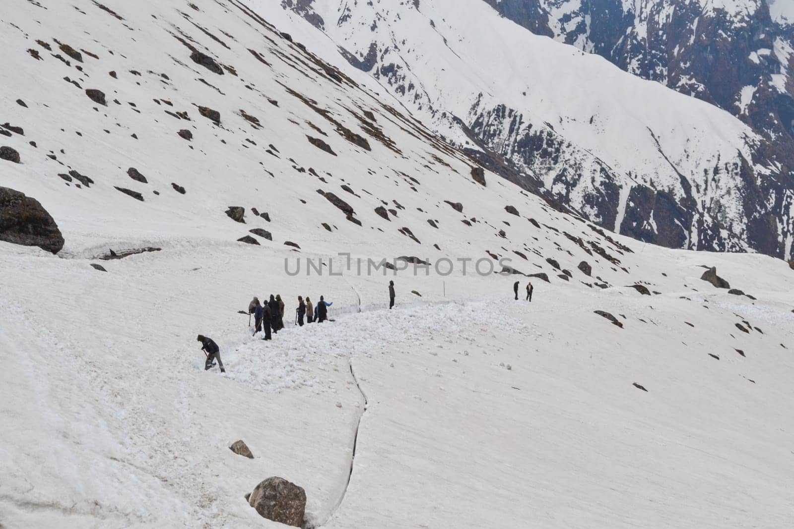 Laborer reopening Kedarnath trek locked by snowfall. Kedarnath is ancient and magnificent temple is located in the Rudra Himalaya range, is over a thousand years old.