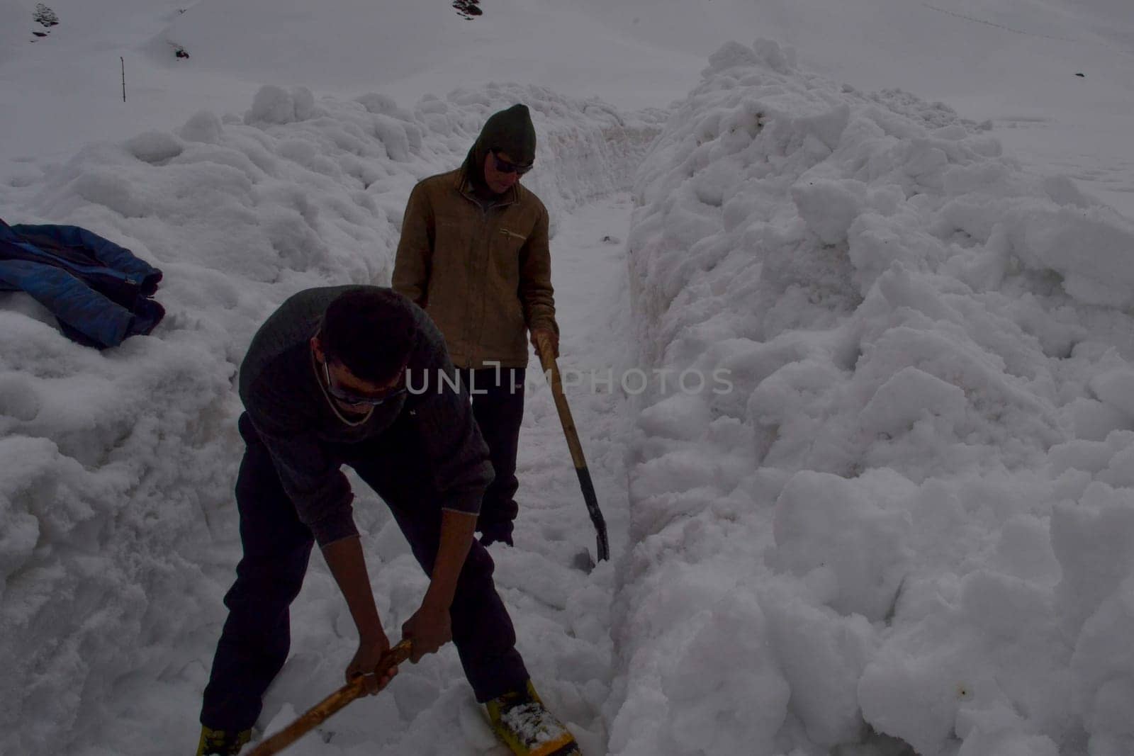 Rudarprayag, Uttarakhand, India, April 26 2014, laborer opening the snow-covered Kedarnath temple route. Kedarnath is a town in the Indian state of Uttarakhand and has gained importance because of Kedarnath Temple.