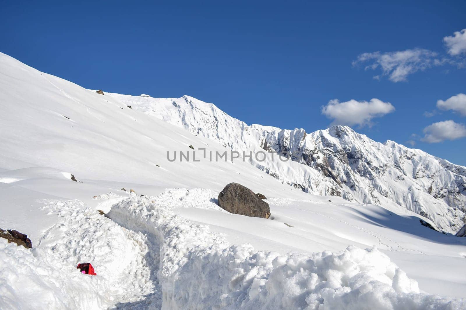 Snow-covered Kedarnath temple route in Himalaya. Kedarnath is a town in the Indian state of Uttarakhand and has gained importance because of Kedarnath Temple.