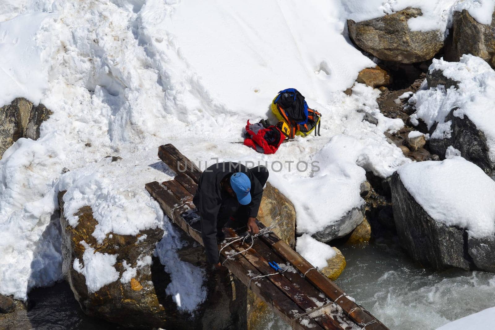 Laborer rebuilding, repairing bridge damaged in Kedarnath Disaster. by stocksvids