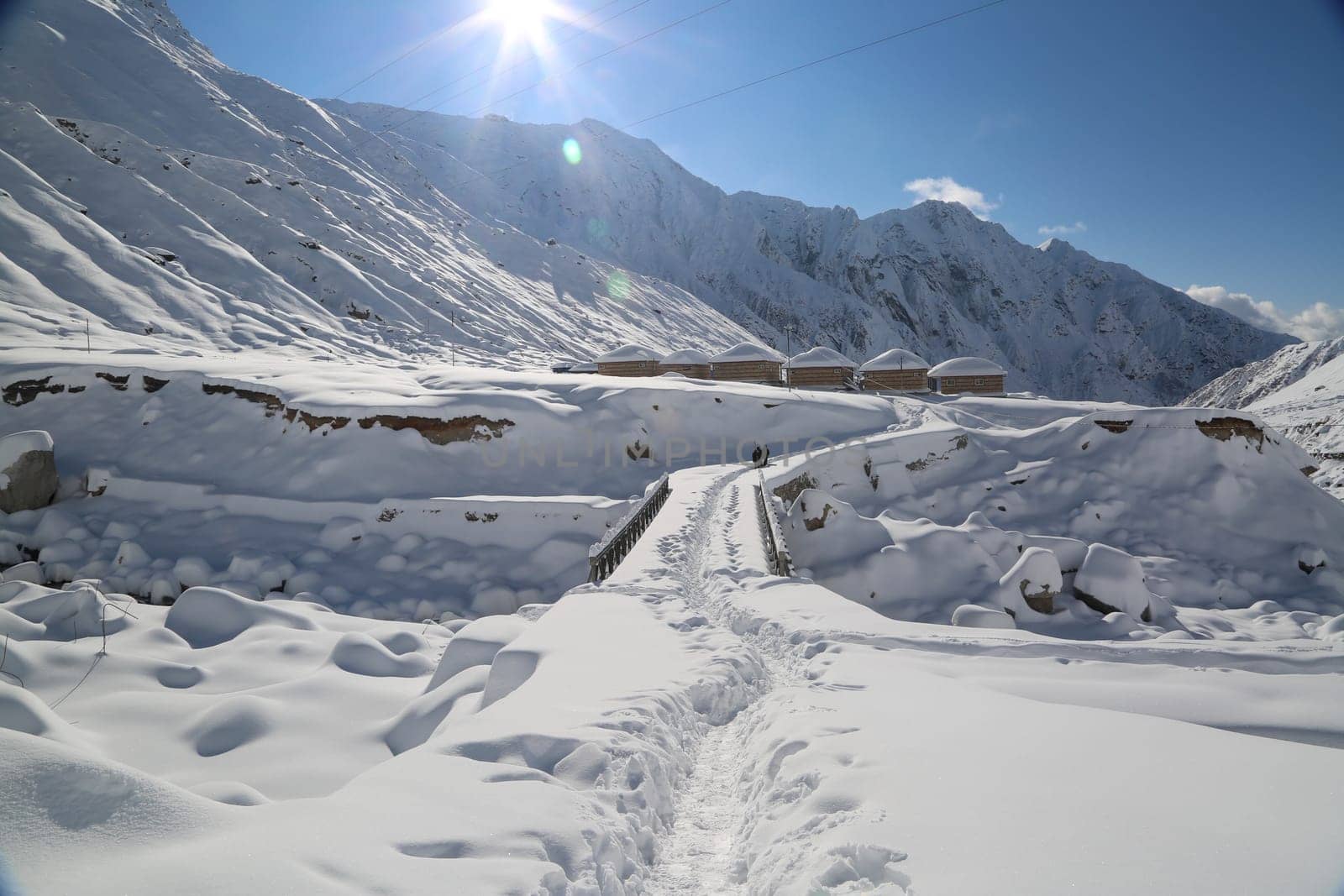 Snow covered mountain peaks and sun raise in Himalaya. by stocksvids