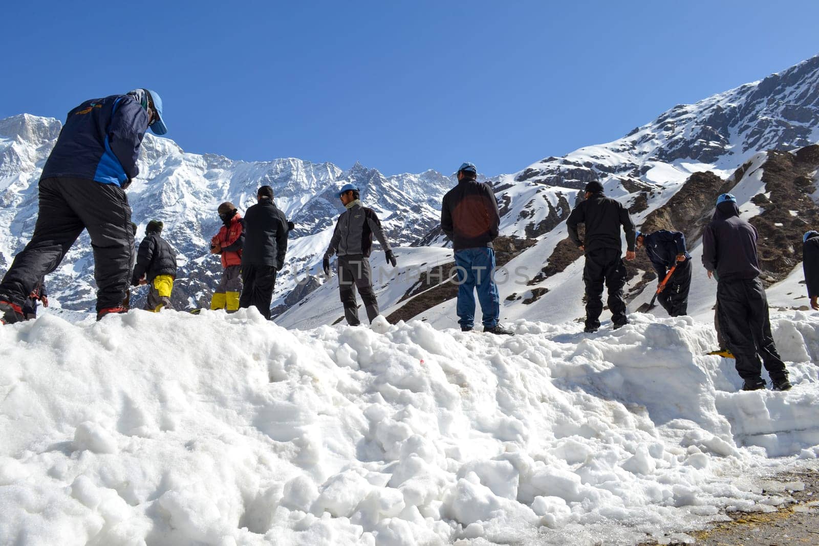 Laborer opening the snow-covered Kedarnath temple route by stocksvids