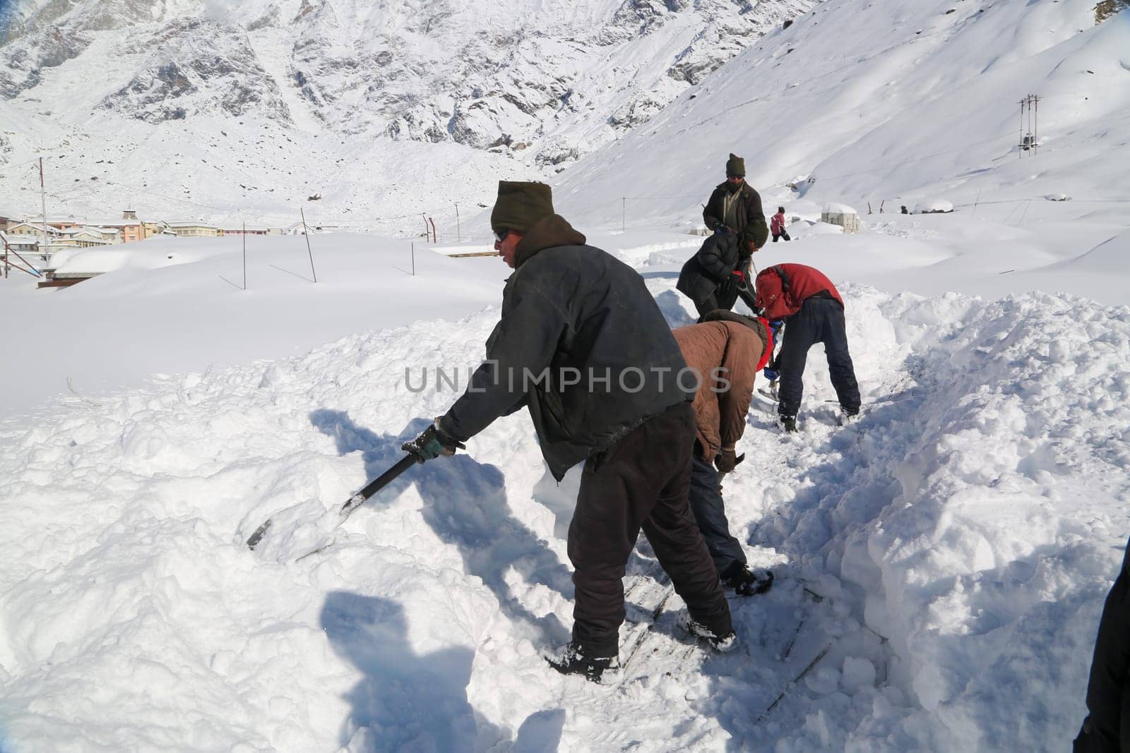 Rudraprayag, Uttarakhand, India, December 12 2014, Laborers opening Kedarnath trek blocked due to snowfall. Kedarnath is a town in the Indian state of Uttarakhand and has gained importance because of Kedarnath Temple.