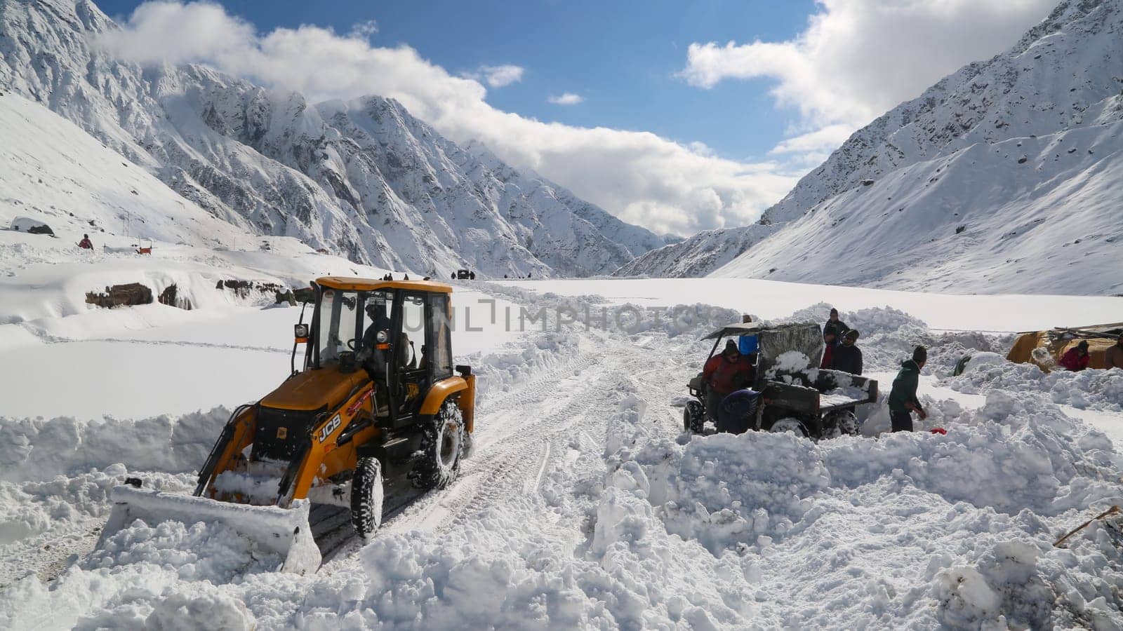 JCB machine working in snowfall in kedarnath reconstruction. by stocksvids