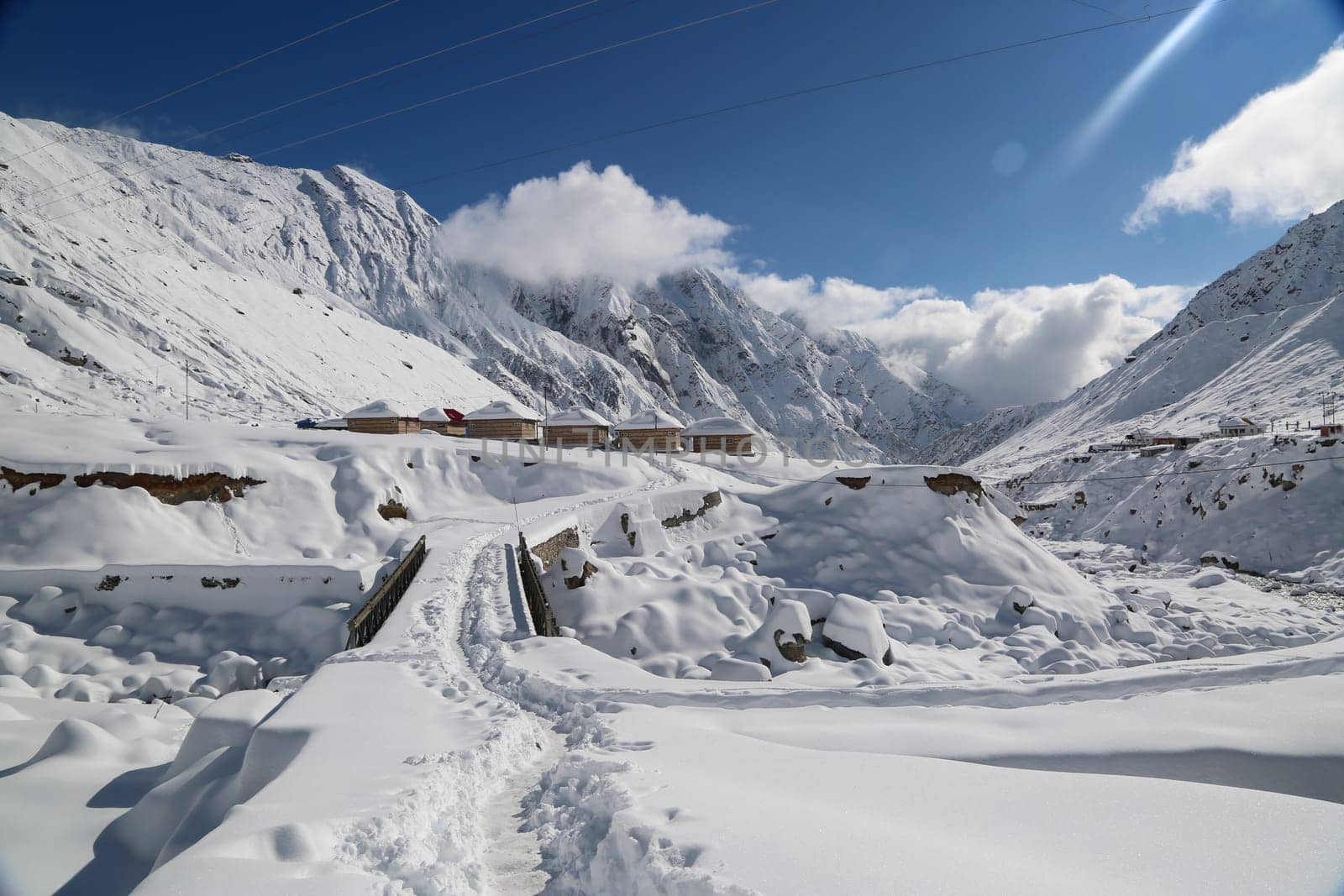 Snow covered mountain peaks and sun raise in Himalaya. by stocksvids