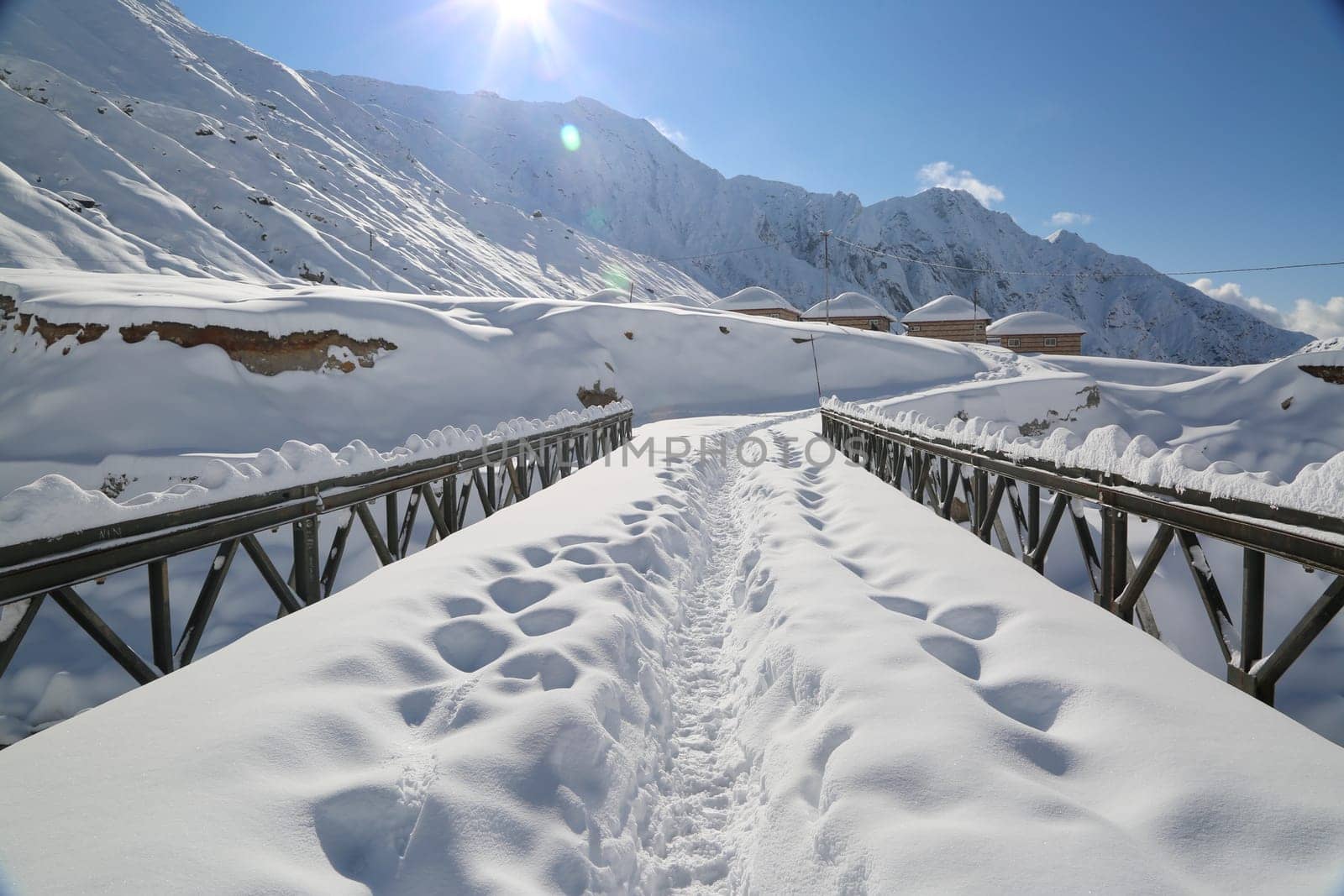 Snow covered mountain peaks and sun raise in Himalaya. by stocksvids