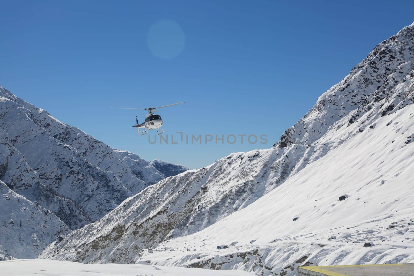 Helicopter flying in snow covered valley of Mountain in Himalaya. by stocksvids