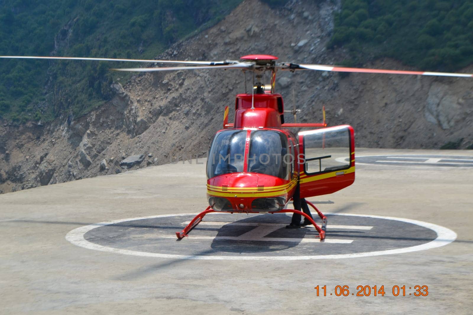 A helicopter landed on the helipad in India. A helicopter is a type of rotorcraft in which lift and thrust are supplied by horizontally-spinning rotors.