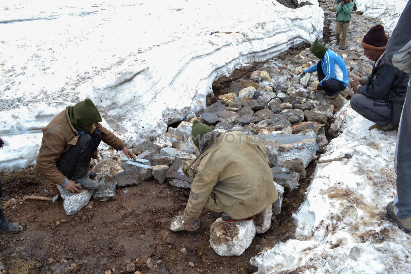 Rudarprayag, Uttarakhand, India, May 18 2014, Laborer reopening Kedarnath trek locked by snowfall. Kedarnath is ancient and magnificent temple is located in the Rudra Himalaya range, is over a thousand years old.