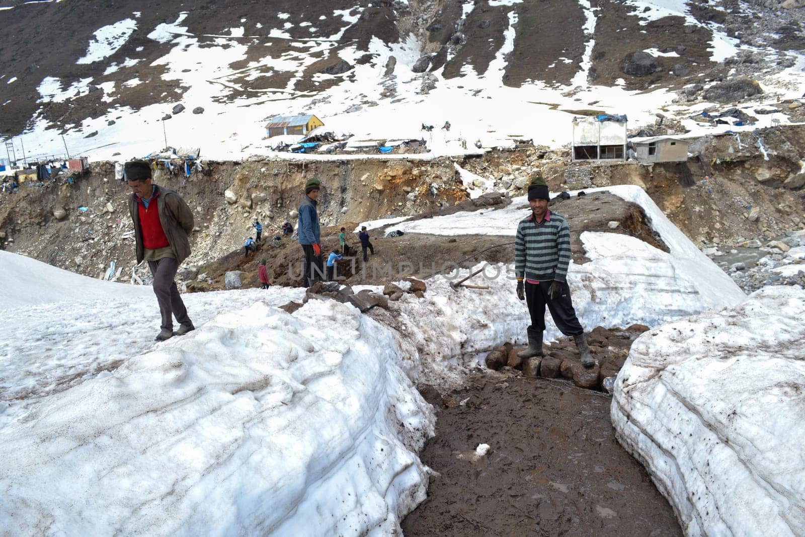 Rudarprayag, Uttarakhand, India, May 18 2014, Laborer reopening Kedarnath trek locked by snowfall. Kedarnath is ancient and magnificent temple is located in the Rudra Himalaya range, is over a thousand years old.