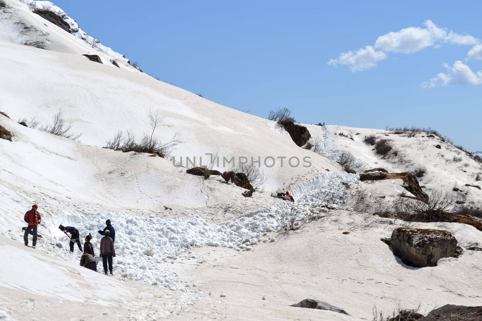 Laborer opening the snow-covered Kedarnath temple route by stocksvids