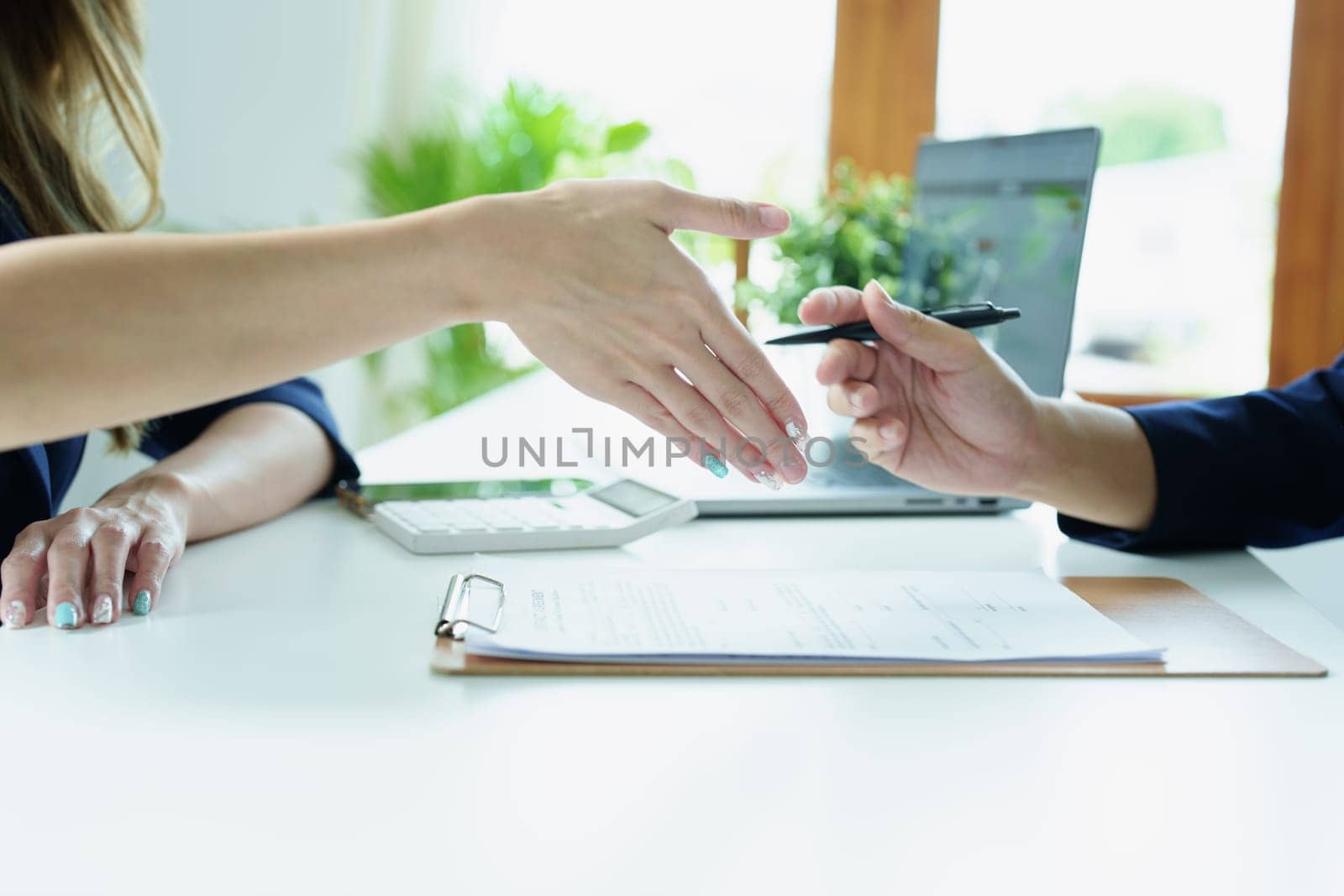 Asian entrepreneurs handshakes to congratulate the agreement between the two companies to enhance investment and financial strength. deal concept.