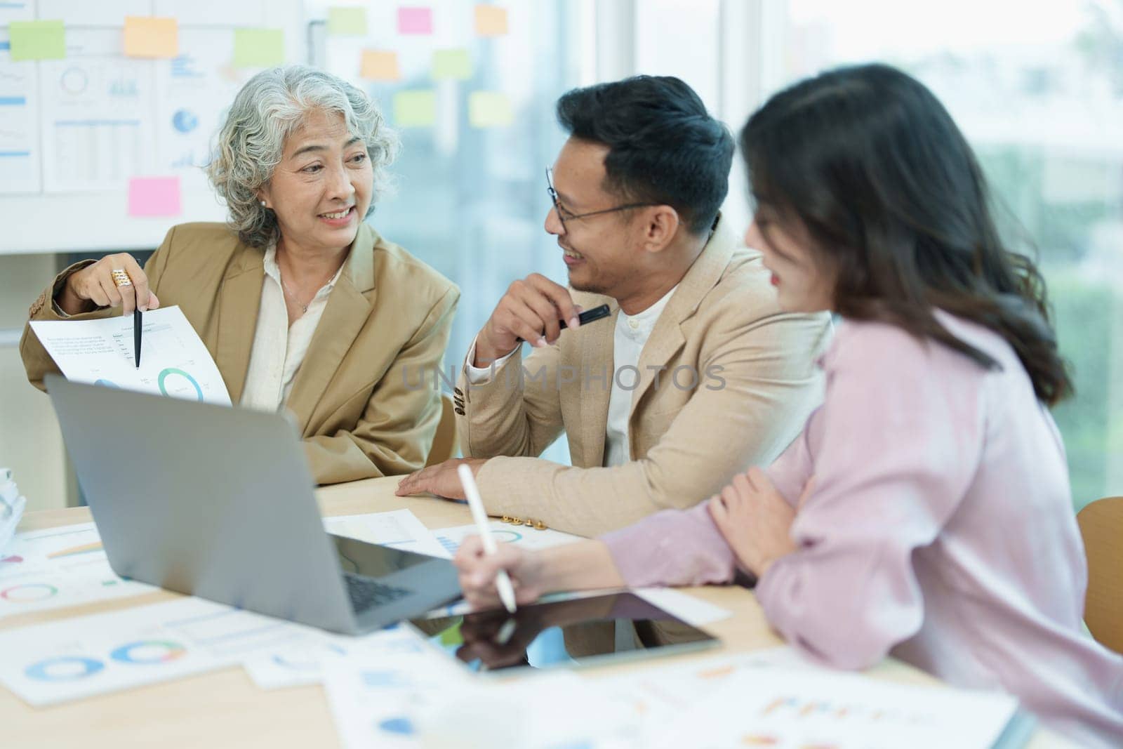 Asian entrepreneurs and business people meeting in a conference room in business planning, financial budget and investment risk assessment to analyze customer groups to increase company growth by Manastrong