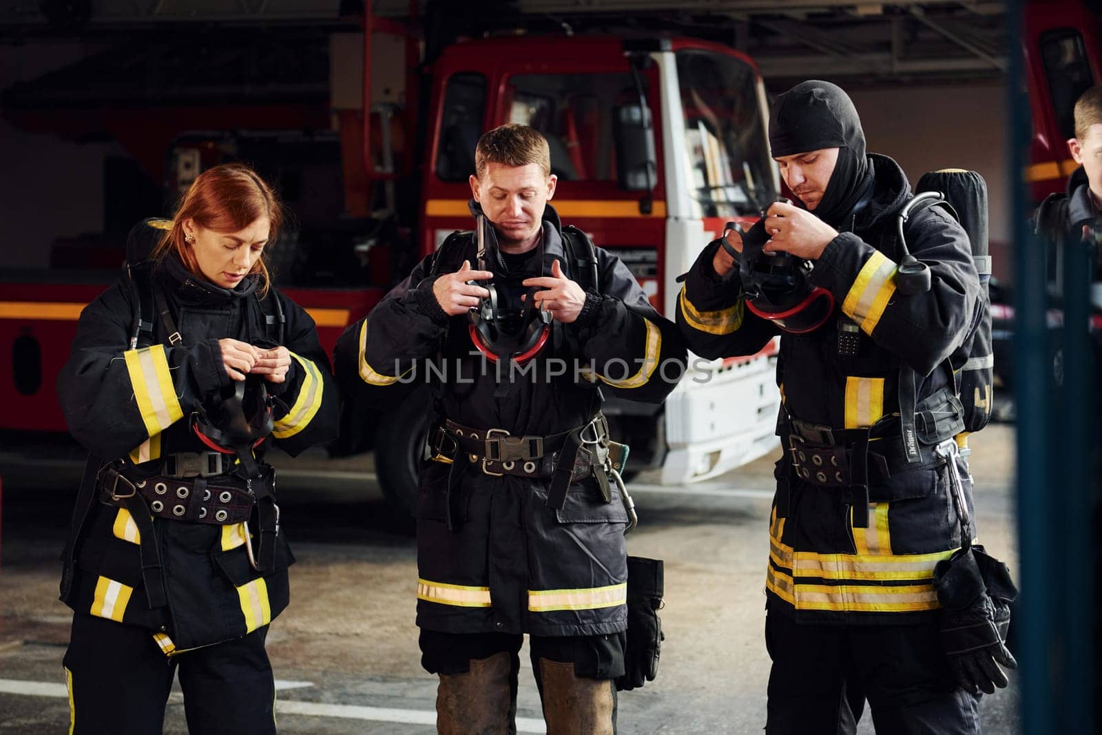Wearing protective uniform. Group of firefighters that is on station.