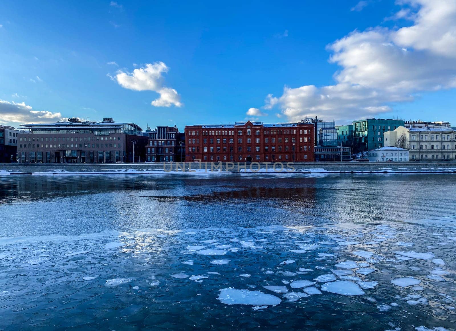 Spring, Moscow river. Moscow river with pieces of ice and embankment.