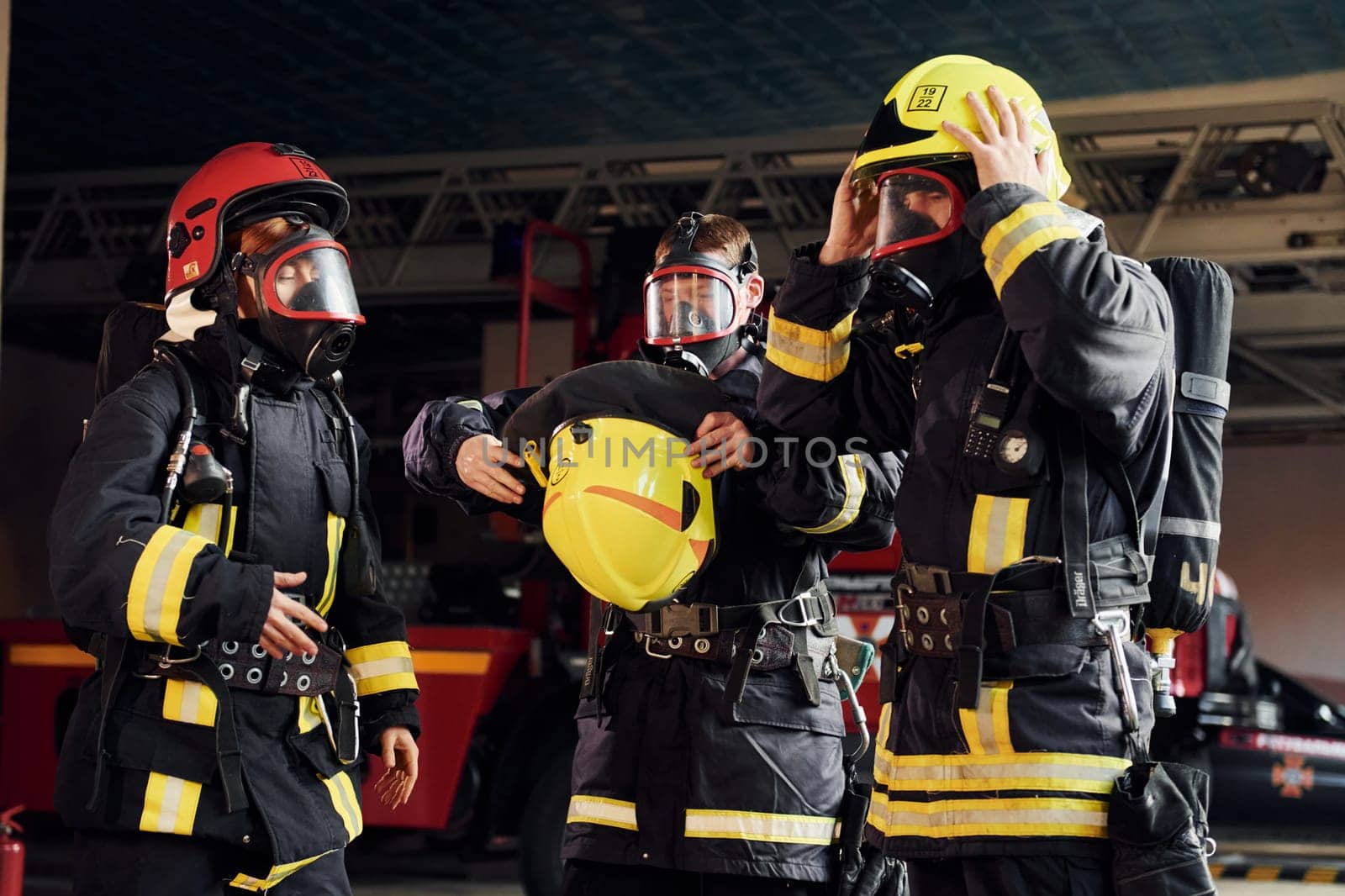 Wearing protective uniform. Group of firefighters that is on station.