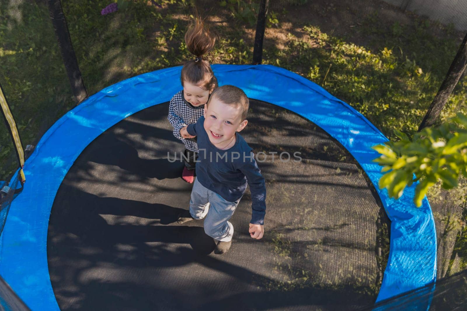 children jump on the trampoline by zokov