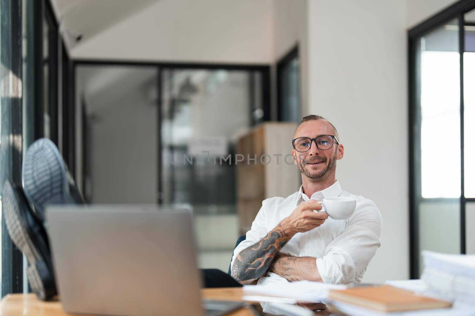 Portrait of successful business man, businessman in glasses and business suit looking at camera and smiling.