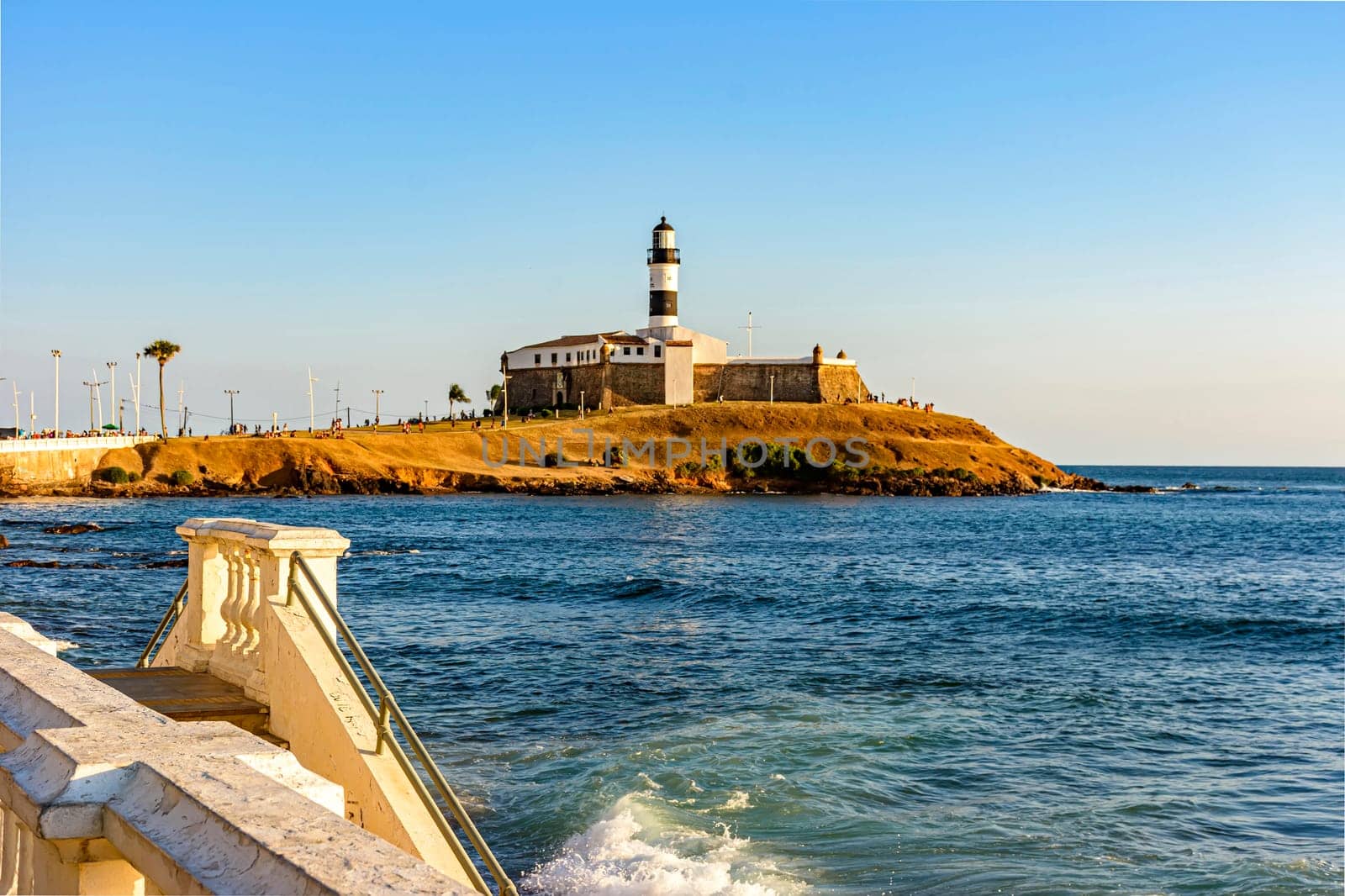 Barra Lighthouse, one of the main tourist spots in Salvador in Bahia surrounded by the sea during the late summer afternoon