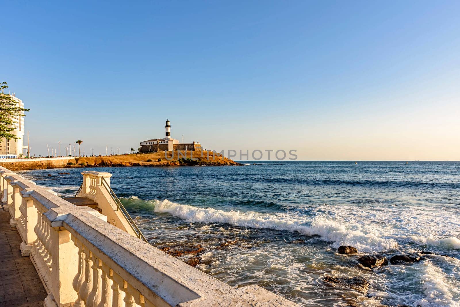 Barra Lighthouse, one of the main tourist spots in Salvador in Bahia surrounded by the sea and city during the late summer afternoon