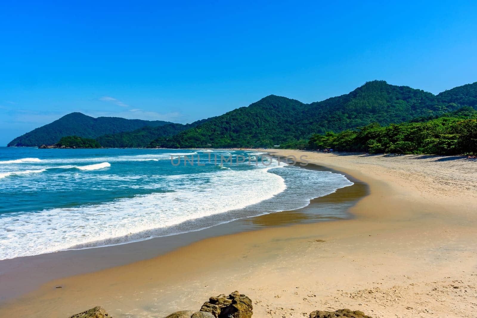 Beach in Bertioga on the north coast of the state of Sao Paulo surrounded by untouched forest and mountains