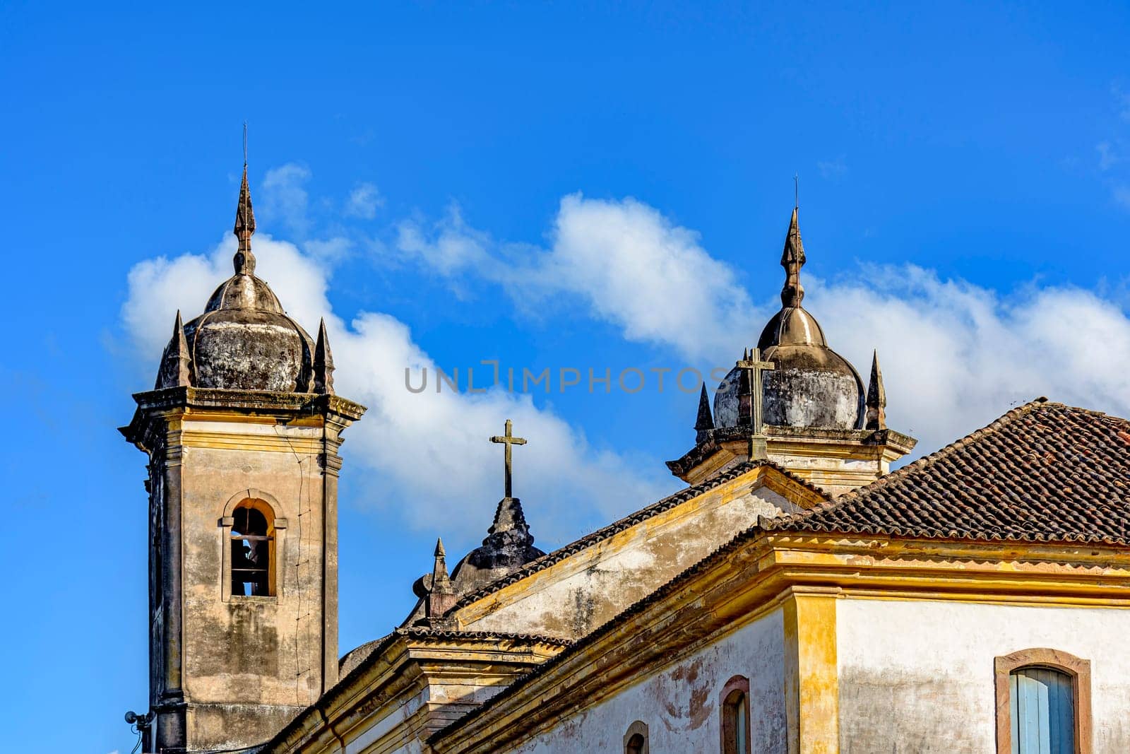 Beautiful historic church in baroque style with its towers jutting out against the blue sky in Ouro Preto, Minas Gerais