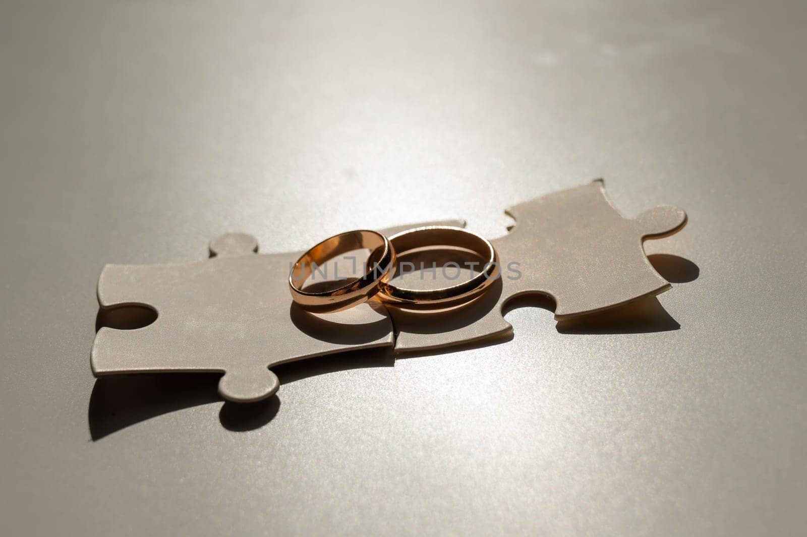 Wedding rings and puzzle pieces. Husband and wife complement each other perfectly. by mrwed54