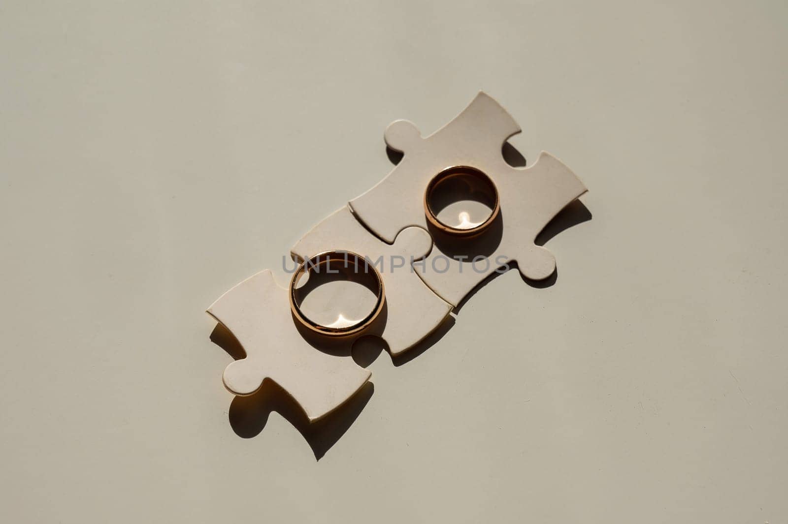 Wedding rings and puzzle pieces. Husband and wife complement each other perfectly