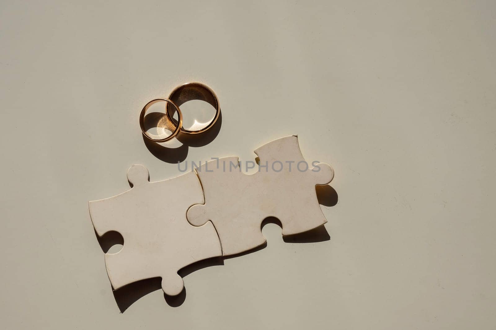 Wedding rings and puzzle pieces. Husband and wife complement each other perfectly