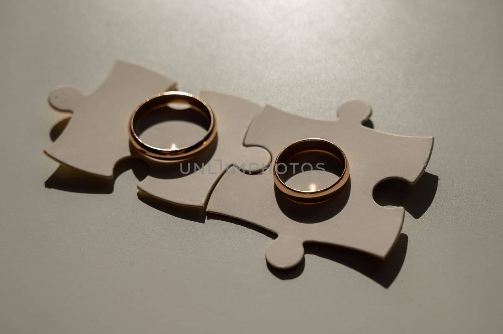 Wedding rings and puzzle pieces. Husband and wife complement each other perfectly