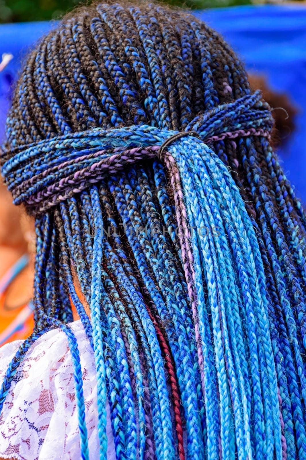 Long blue braids worn by a member of a carnavaval association in Rio de Janeiro for presentation