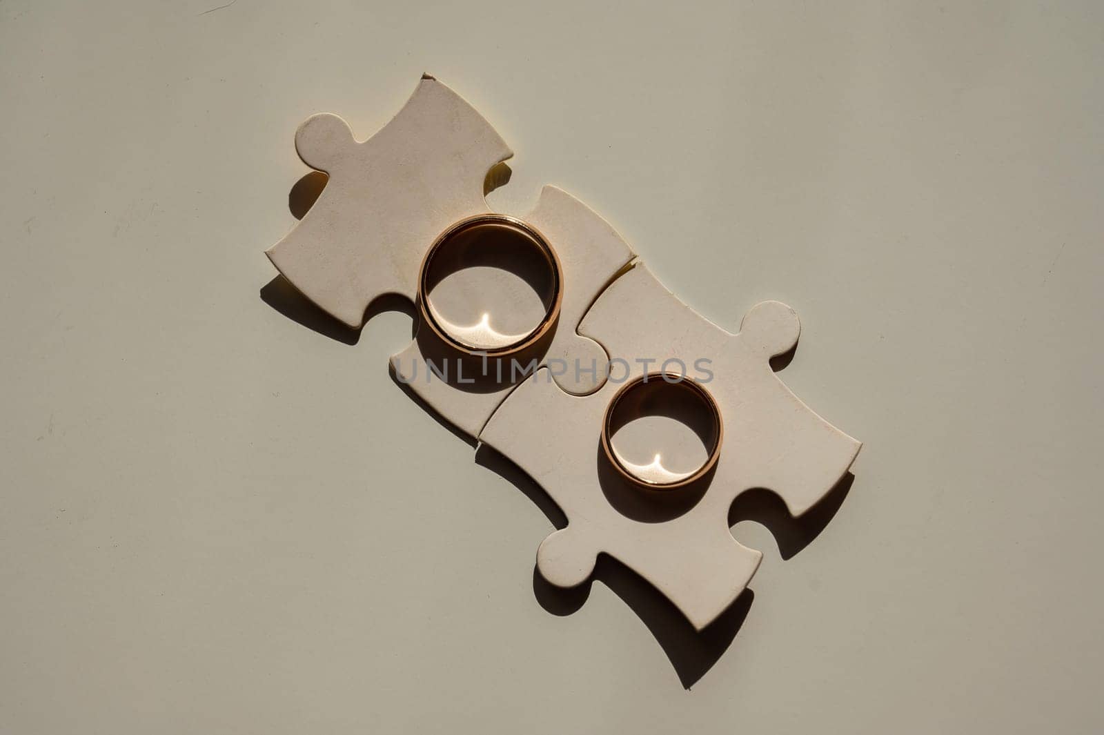 Wedding rings and puzzle pieces. Husband and wife complement each other perfectly