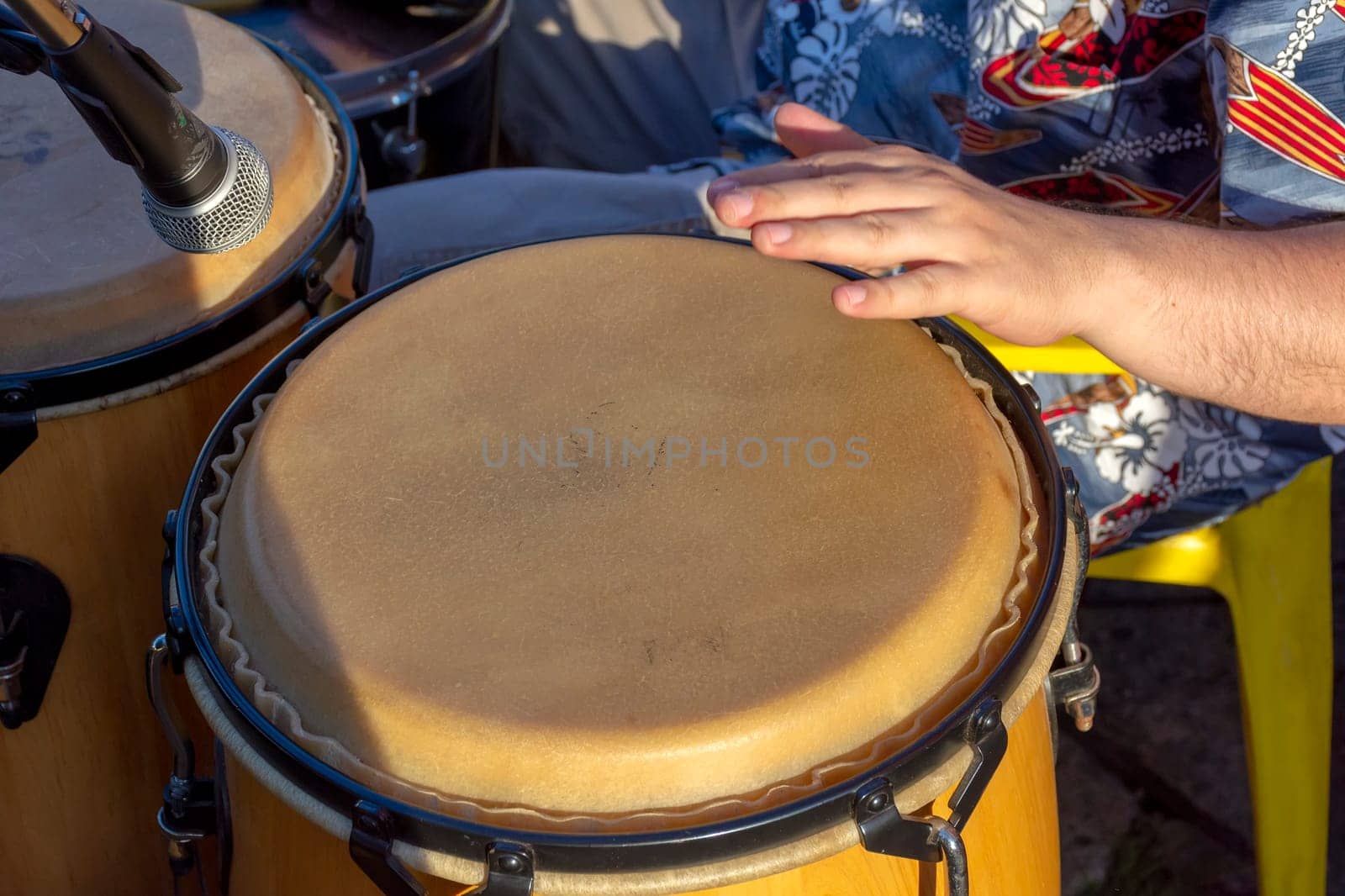 Detail of man playing atabaque during party at the carnival of the city of Belo Horizonte, Minas Gerais