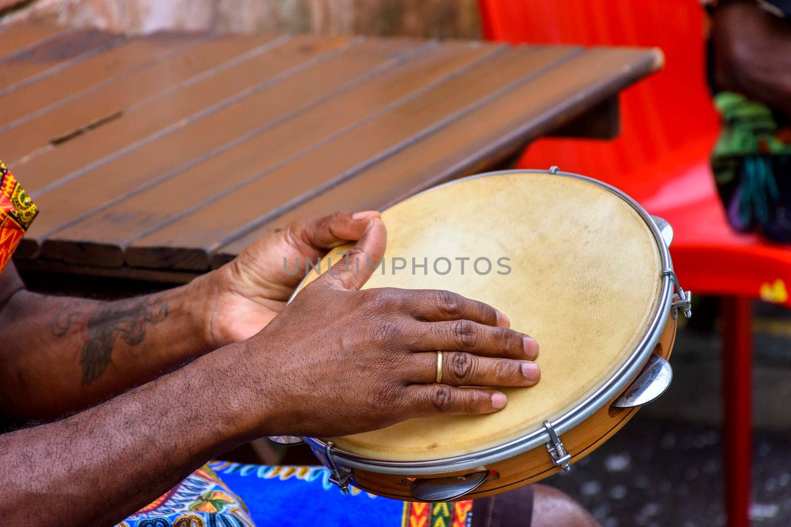 Brazilian samba performance with musician playing tambourine in the streets of Pelourinho, city of Salvador, Bahia
