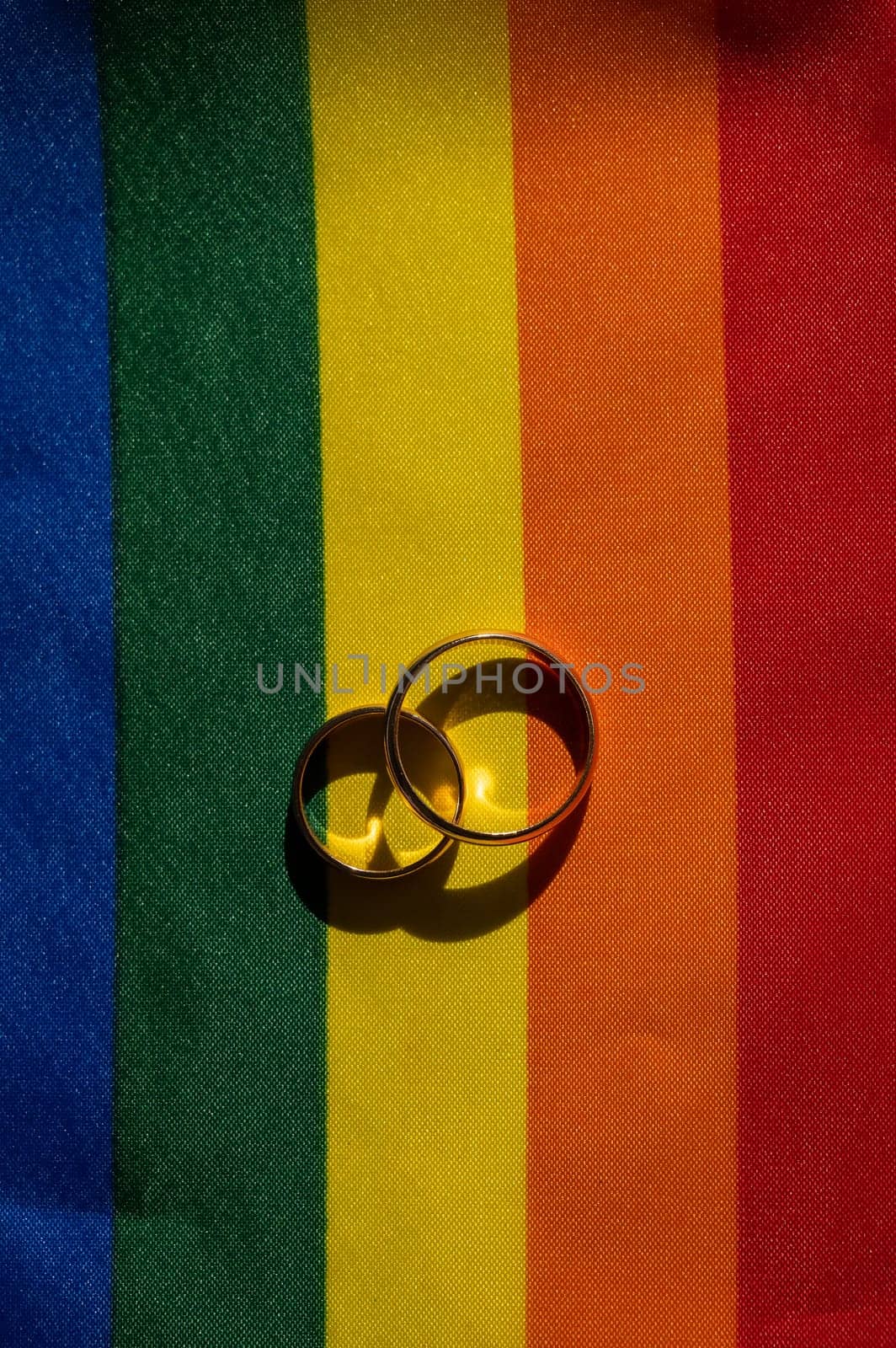 Legalization of same-sex marriages. Rainbow flag and wedding rings. by mrwed54